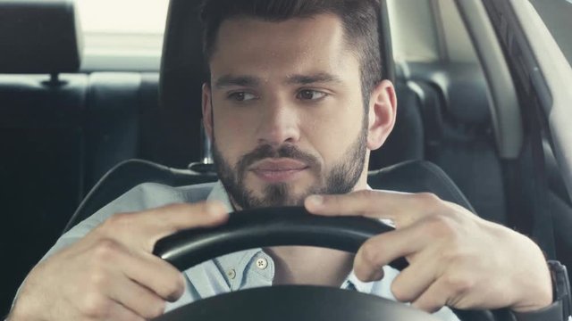 selective focus of sweaty man touching shirt while sitting in car and holding steering wheel 
