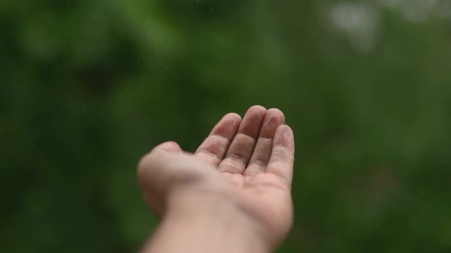 Male Hand covered in droplets of Rain