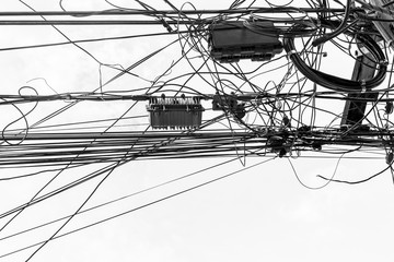 Confused cable On the power poles on blue sky