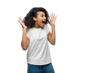 Obraz na płótnie Canvas excited curly african american girl gesturing isolated on white