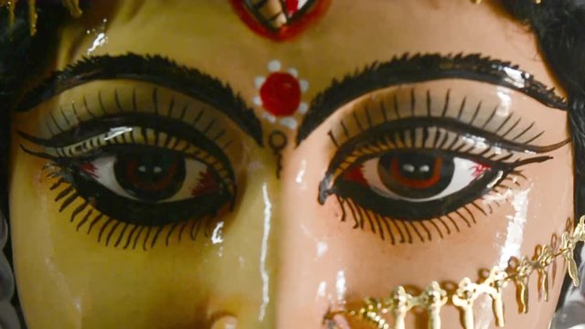 Close up front view face of Goddess Maa Durga Idol. A symbol of strength and power as per Hinduism. Portrait was taken during Durga Puja celebrations from a famous potter studio in Kumartuli in Kolkat
