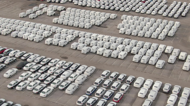 DRONE: Flying Above A Car Park Reserved For Brand New Cars Coming In From Port.