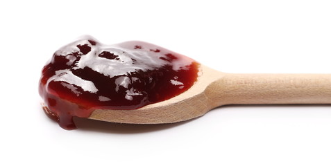 Cherry jam, marmalade with wooden spoon isolated on white background