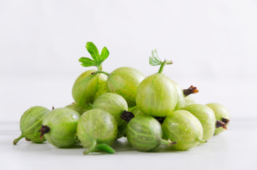 Closeup of fresh harvest of ripe gooseberries on the white background
