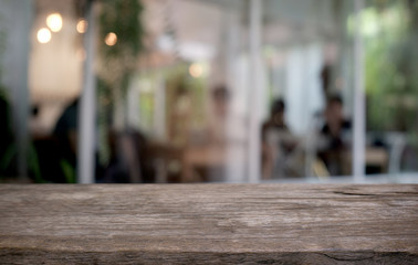 Empty dark wooden table in front of abstract blurred bokeh background of restaurant . can be used for display or montage your products.Mock up for space.