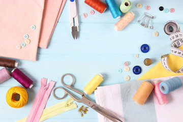 sewing accessories on a colored background top view.