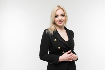 charming blonde girl in black costume possing on background