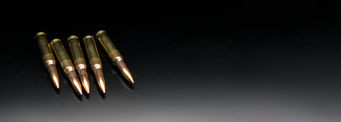 Bullet isolated on black background with reflexion. Rifle bullets close-up on black back. Cartridges for rifle and carbine on a black.