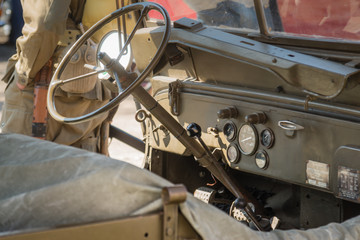 An old military vehicle during a sunny day.