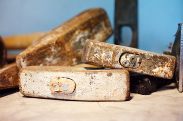Old destroyed hammers among other hand tools