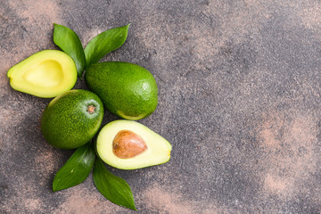 Fresh ripe avocados on grey background