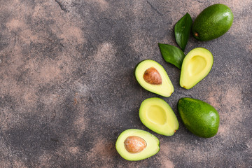 Fresh ripe avocados on grey background