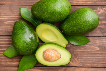 Fresh ripe avocados on wooden background