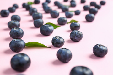 Many ripe blueberry on color background