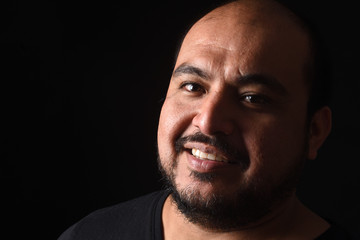 Fototapeta premium portrait of a latin american man on black