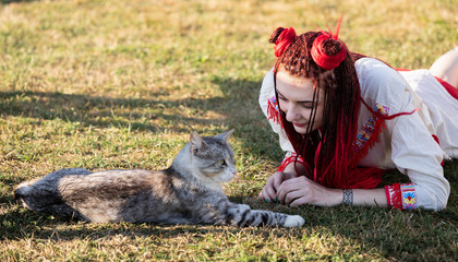 Young woman playing with cat