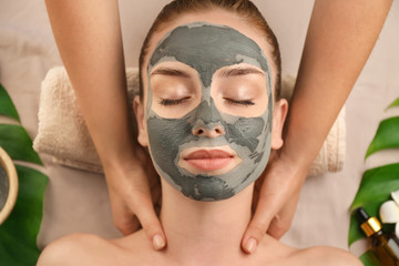 Fototapeta premium Beautiful young woman relaxing in spa salon, top view