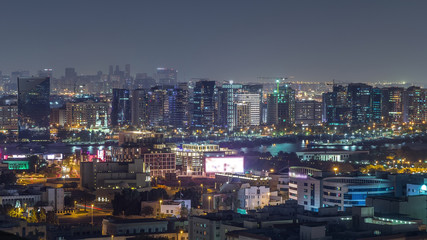 Fototapeta na wymiar Aerial view of neighbourhood Deira with typical buildings night timelapse, Dubai, United Arab Emirates