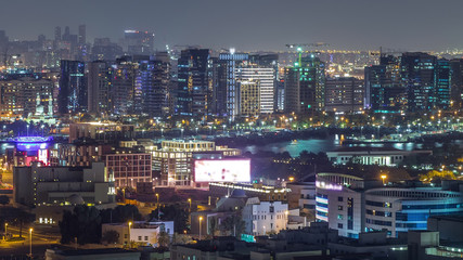 Fototapeta na wymiar Aerial view of neighbourhood Deira with typical buildings night timelapse, Dubai, United Arab Emirates