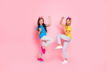 Fototapeta na wymiar Full size photo of cheerful kids scream yeah have aims fortune wear pants trousers headbands isolated over pink background