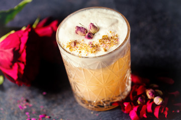 Dusty Rose liquor cocktail with flower decoration