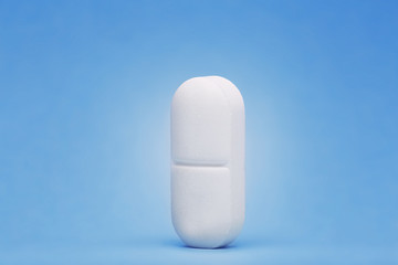 medical pills in white on blue color background with shadow.Concept of healthcare and medicine.