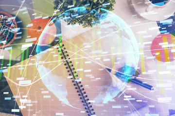 International business hologram over woman's hands taking notes background. Concept of success. Double exposure