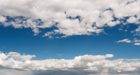 white clouds float in the evening sky
