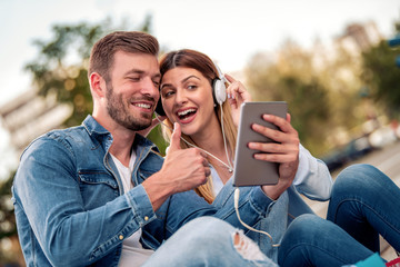 Couple listening  to music outside