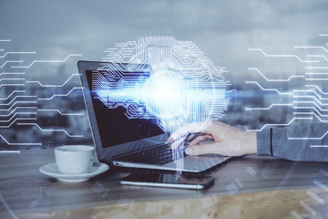 Businessman with computer background with brain theme hologram. Concept of brainstorm. Multi exposure.