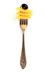 Italian pasta. An overhead photo of a vintage fork with penne and a black olive on a white background with a place for text