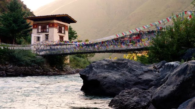 Suspension bridge covered in prayer flags near Paro, Bhutan