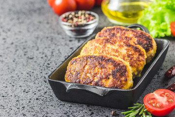 Chicken cheese vegetable rissoles in cast iron skillet. Selective  focus, space for text.