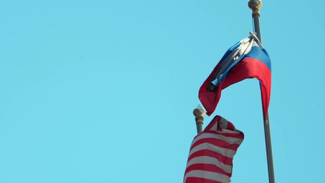 Flags of Russia and United States on blue sky background