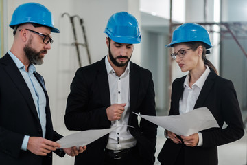 Engineers in hardhats have conversation