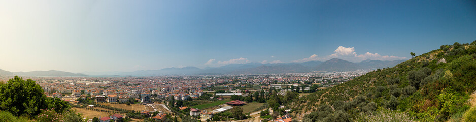 Fototapeta na wymiar Looking out over the fishing town of Fethiye, Turkey on a clear sunny day panoramic