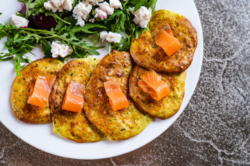 Pancakes with greek salad and salmon