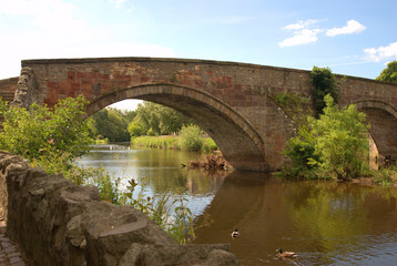 old stone bridge over river Tyne, Haddington in summer