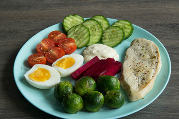Chicken fillet, Brussels sprouts, eggs, tomatoes, cucumbers, white sauce