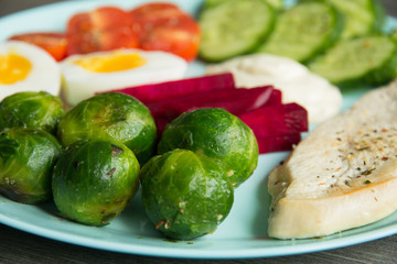 Chicken fillet, Brussels sprouts, eggs, tomatoes, cucumbers, white sauce