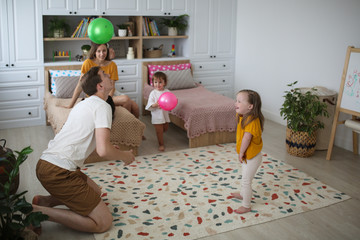 Caucasian family playing with balls at home