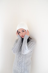 Asian girl, shot body length, is wearing a winter outfit with a cute emotion