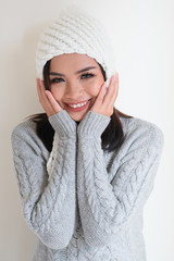 Asian girl, shot body length, is wearing a winter outfit with a cute emotion
