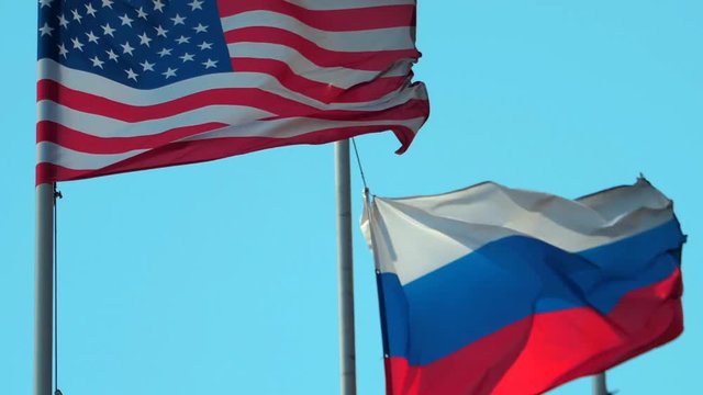 Flags of Russia and United States on blue sky background