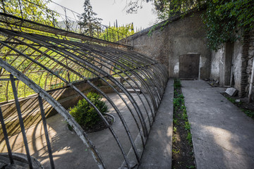 old broken down glass house in botanical garden tbilisi