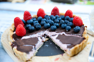 Homemade Chocolate cake with fresh blueberries  raspberries