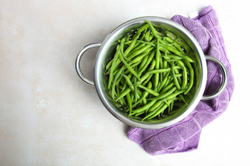 String beans in metal colander