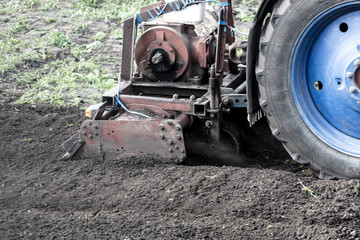 Tractor plowing soil in spring