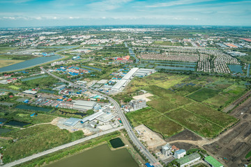 the view of green field and farm and city downtown in middle of Thailand. It shot from Jetplane.