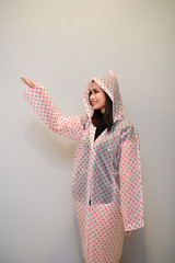 Asian girl with nice outfit, wearing a raincoat